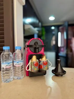 two bottles of water are sitting next to a tea kettle at appartement avec piscine et charme marocain in Marrakech