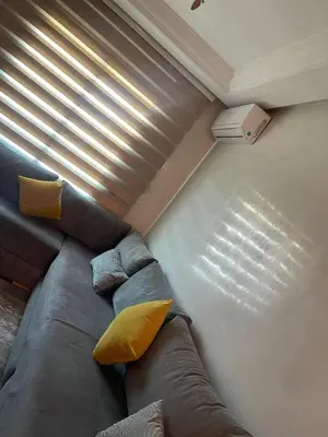 a large couch in a room with a window at Mobarak immo Appt 10 in Marrakech