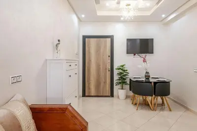 a living room with a table and a door at Moroccan Comfort & Charm - 10 min from Guéliz in Marrakech