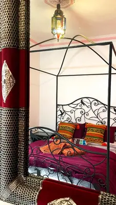a bedroom with a bed with a metal frame at Riad Serenity Palmeraie in Marrakech