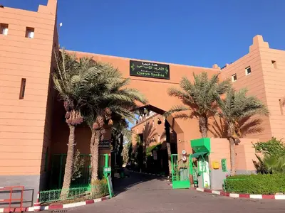 a building with palm trees in front of it at Riad Serenity Palmeraie in Marrakech