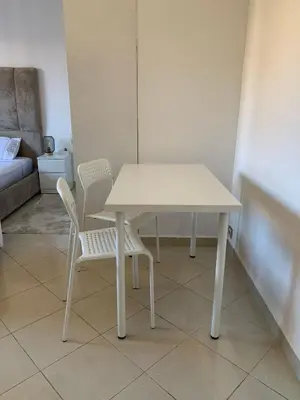 a white table and two chairs in a room at Studio Stay Marrakech in Marrakech