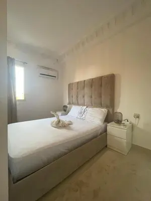 a bedroom with a large white bed with a headboard at Studio Stay Marrakech in Marrakech