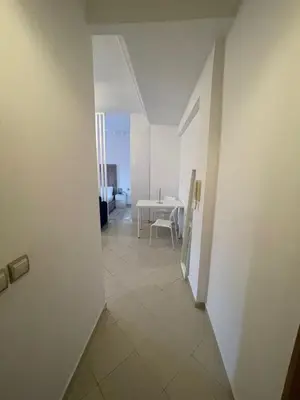 a view of a hallway with a table and a room at Studio Stay Marrakech in Marrakech