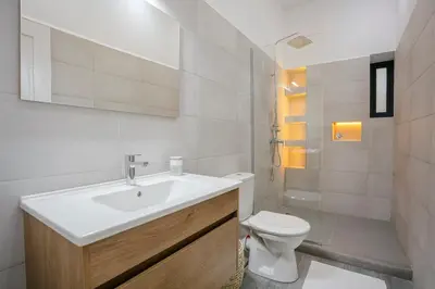 a white bathroom with a sink and a toilet at 2BR Art Deco Loft - Central Gueliz Marrakech in Marrakech
