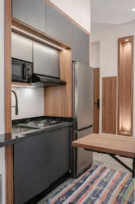 a kitchen with stainless steel appliances and a wooden table at 2BR Art Deco Loft - Central Gueliz Marrakech in Marrakech
