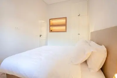 a bedroom with a large white bed with a window at 2BR Art Deco Loft - Central Gueliz Marrakech in Marrakech