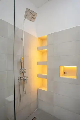 a bathroom with a shower with a glass door at 2BR Art Deco Loft - Central Gueliz Marrakech in Marrakech