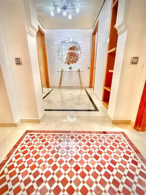 a hallway with a checkered floor in a house at Appartement Plaza Centre in Marrakech