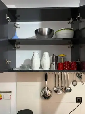 a kitchen with utensils on a shelf with at Modern apartment in the heart of Marrakech, just 9 minutes from the airport in Marrakech