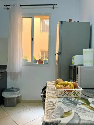 a table in a kitchen with a bowl of fruit at Modern apartment in the heart of Marrakech, just 9 minutes from the airport in Marrakech