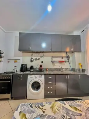 a kitchen with a sink and a washing machine at Modern apartment in the heart of Marrakech, just 9 minutes from the airport in Marrakech