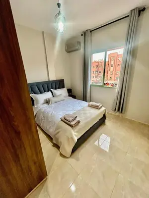 a bedroom with a bed and a large window at Cozy Apartment 10 minutes from Gueliz and Medina in Marrakech
