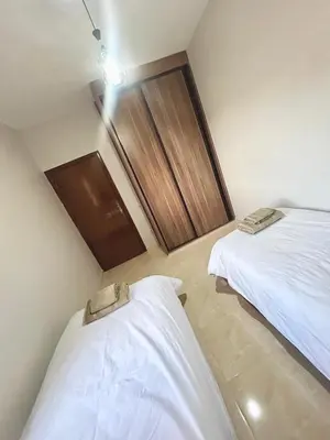 a room with two beds in a room at Cozy Apartment 10 minutes from Gueliz and Medina in Marrakech