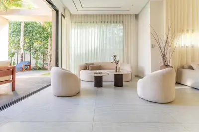 a living room with two white chairs and a table at Villa Lana on stilts luxury and relaxation in Marrakech