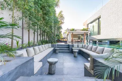 a patio with couches and plants on a building at Villa Lana on stilts luxury and relaxation in Marrakech