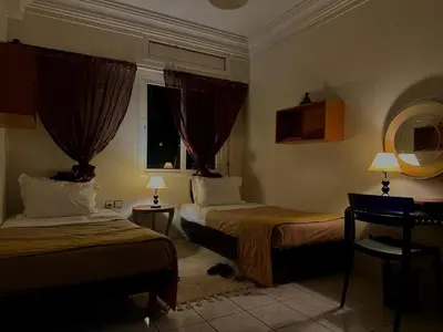a hotel room with two beds and a window at Charming apartment with a traditional style in Marrakech
