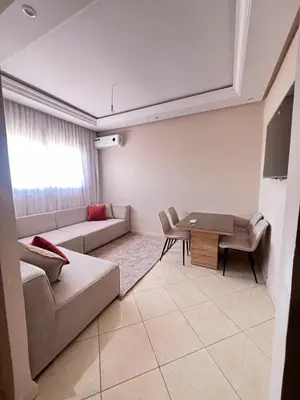 a living room with a couch and a table at M&O airport appartment in Marrakech