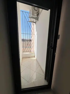 an open door to a room with a window at M&O airport appartment in Marrakech