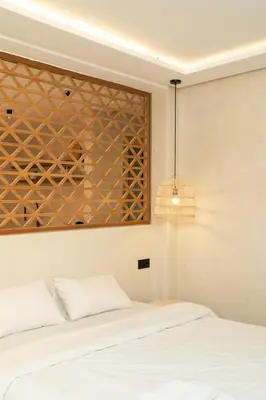 a bedroom with a white bed and a pendant light at Studio de reve au Coeur de Marrakech in Marrakech