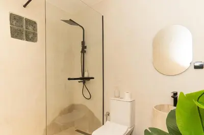 a bathroom with a shower with a toilet and a mirror at Studio de reve au Coeur de Marrakech in Marrakech