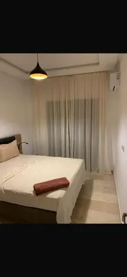 a bedroom with a bed with a towel on it at Marrakech résidence Nour 6 in Marrakech