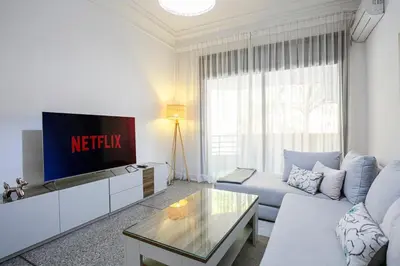 a living room with a couch and a tv at Art Deco Loft 1BR Central Guéliz Marrakech in Marrakech