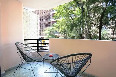 a patio with two chairs and a table on a balcony at Art Deco Loft 1BR Central Guéliz Marrakech in Marrakech