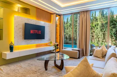 a living room with a couch and a tv at Zen Villa Private Parking in El Rhechat