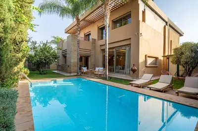 a villa with a swimming pool in front of a house at Zen Villa Private Parking in El Rhechat