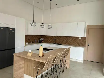 a kitchen with a wooden table and chairs at Villa LAM atlas view in Tameslouht