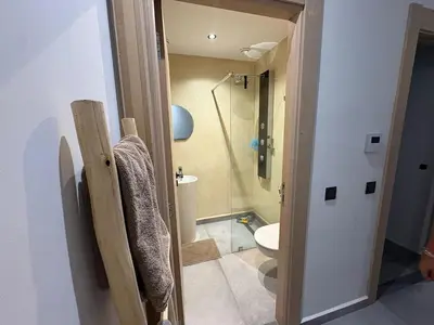 a bathroom with a shower and a toilet in a room at Villa LAM atlas view in Tameslouht