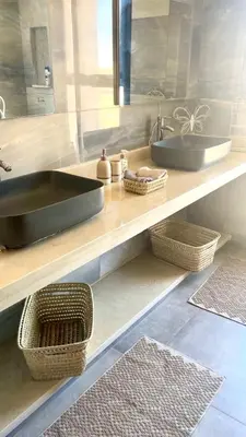 a bathroom with two sinks and baskets on a counter at Villa LAM atlas view in Tameslouht