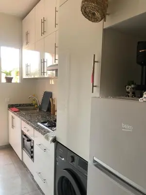 a kitchen with white cabinets and a washer and dryer at Marrakech Authentic 2-Bedroom flat NearGueliz in Marrakech