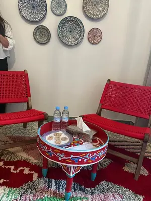 a room with two chairs and a table with water bottles at Riad Nejma Benyoussef in Marrakech