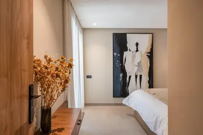 a bedroom with a bed and a vase with flowers at L'Amira - Super Apartment with Terrace - 2 people - Wifi in Marrakech