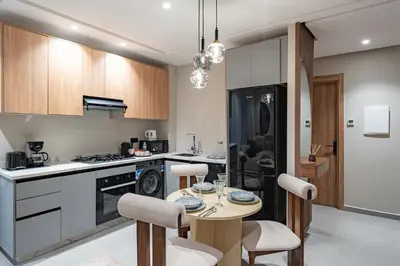 a kitchen with a table and chairs in a room at L'Amira - Super Apartment with Terrace - 2 people - Wifi in Marrakech