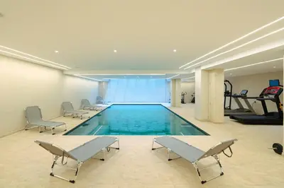 a large swimming pool with chairs and a gym at L'Amira - Super Apartment with Terrace - 2 people - Wifi in Marrakech