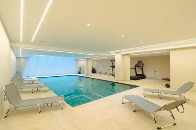 a large swimming pool with chairs and a gym at L'Amira - Super Apartment with Terrace - 2 people - Wifi in Marrakech
