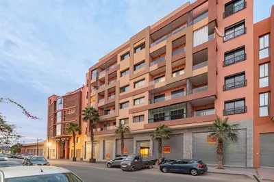 a large building with cars parked in front of it at L'Amira - Super Apartment with Terrace - 2 people - Wifi in Marrakech