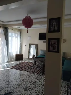 a living room with a couch and a mirror at Dar Kawtar in Marrakech