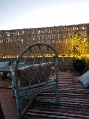 a bench sitting on a patio with a fence at Dar Kawtar in Marrakech