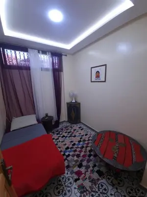a bedroom with a red bed and a window at Dar Kawtar in Marrakech