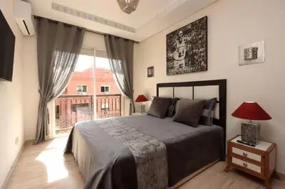 a bedroom with a bed and a large window at Apartment in the Heart of Marrakech 5th Floor in Marrakech