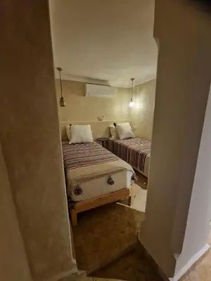 a view of two beds in a room at Riad La Brune in Marrakech