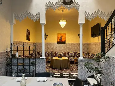 a dining room with a table and chairs at Riad Flouris in marrakech in Marrakech
