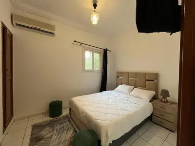 a bedroom with a large bed and a window at Riad Flouris in marrakech in Marrakech