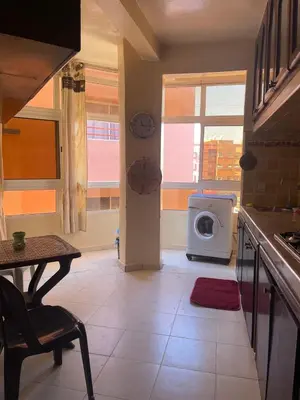 a kitchen with a washing machine in a room at Apparemment alhamra in Marrakech