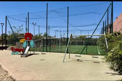 a batting cage in a park with a playground at Superbe appart 3p confort avec terrasse et vu piscin in Marrakech