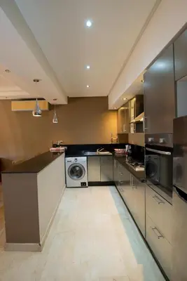 a large kitchen with a washer and dryer at Gueliz carree Eden apartment in Marrakech